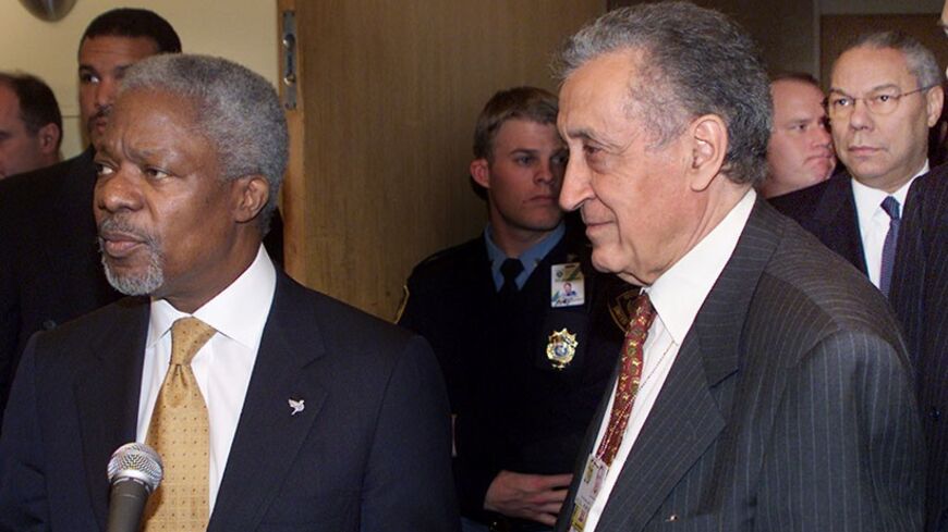 United Nations Secretary General Kofi Annan (L) speaks to the media
with Lakhdar Brahimi (R), Special Representative of the Secretary
General for Afghanistan, as United States Secretary GEneral Colin
Powell looks on (Back R) folowing a high level "Six plus Two" meeting
at United Nations headquarters in New York, November 12, 2001. The
meeting was held between Foreign Ministers of the six countries
bordering Afghanistan as well as the United States and Russia to
discuss the current conflict in the region. RE