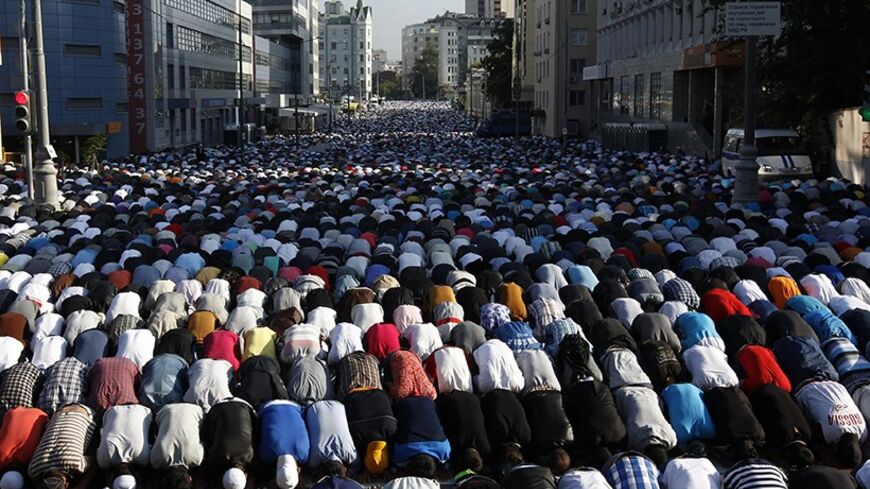 Thousands of believers take part in morning prayers to celebrate the first day of Eid-al-Fitr in Moscow August 8, 2013. The Eid al-Fitr festival marks the end of the Muslim holy fasting month of Ramadan. REUTERS/Sergei Karpukhin (RUSSIA - Tags: RELIGION) - RTX12DN1
