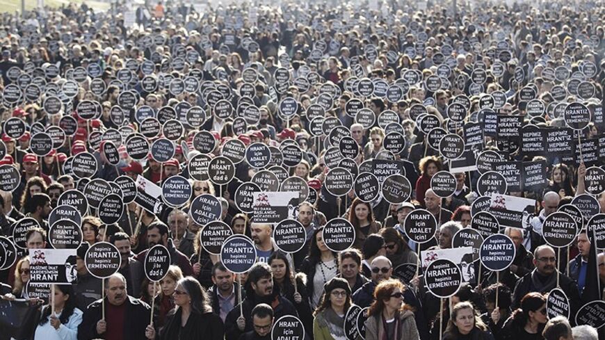 Protesters march to Agos newspaper office during a demonstration to mark the seventh anniversary of the killing of Turkish-Armenian journalist Hrant Dink in Istanbul January 19, 2014. Dink, the former editor-in-chief of weekly Agos, was shot dead in front of his newspaper building by a Turkish nationalist, who had been sentenced to over 22 years in jail. Protesters also denounced the trial process of several top suspects, whose acquittal was recently overturned by the Supreme Court of Appeals, according to