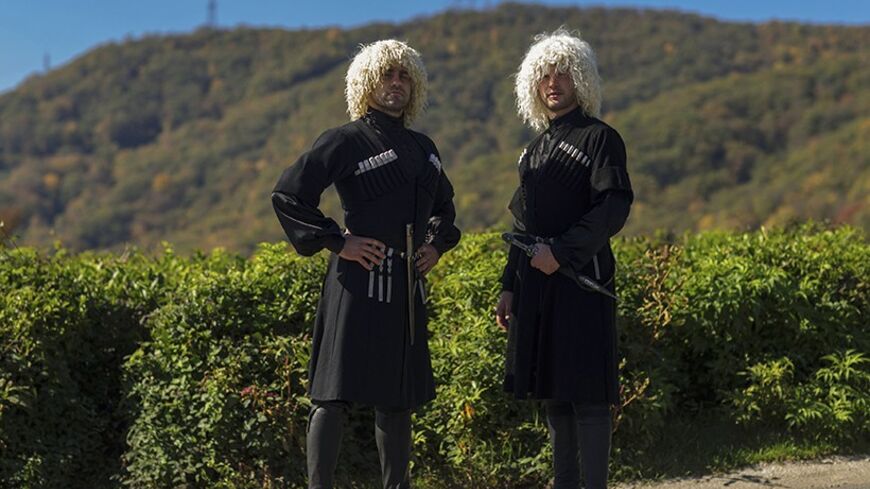Circassian men wearing traditional clothes pose for a photograph in a tea field during the visit of a delegation of diaspora Circassians in Golovinka, near Sochi October 15, 2013. Circassians are a people indigenous to the North Caucasus region, most of whom were scattered across the globe by a 19th century tsarist military campaign that caused the deaths of huge numbers. Many Circassians have called for the killings to be recognised as genocide, and have campaigned against the Sochi 2014 Winter Olympics, s