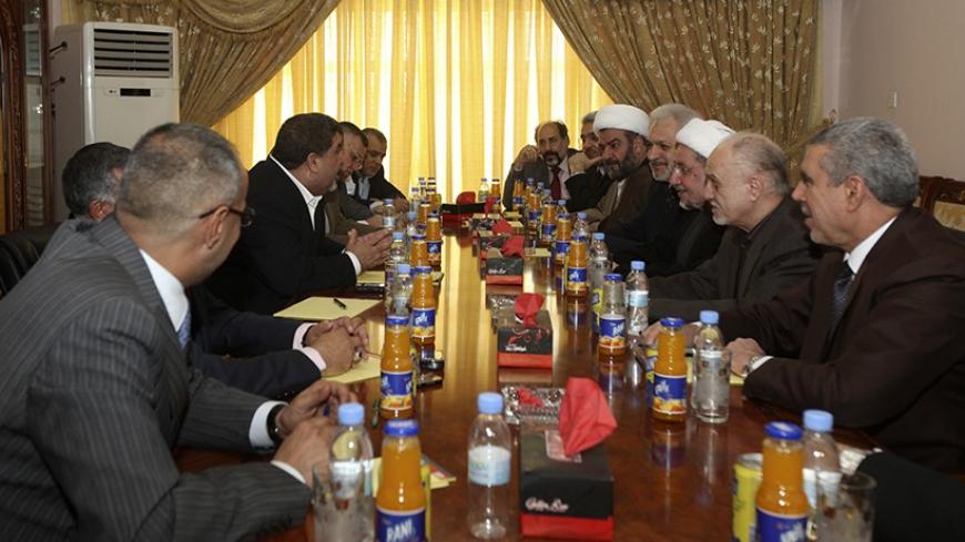 Members of Iraqi National Alliance (INA) and the State of Law (SOL) coalition hold a meeting in Baghdad October 1, 2010. An alliance of Iraq's Shi'ite political blocs picked incumbent Nuri al-Maliki as its nominee for prime minister on Friday, ending months of wrangling that had stalled formation of a government. REUTERS/Mohammed Ameen (IRAQ - Tags: POLITICS) - RTXSWUU