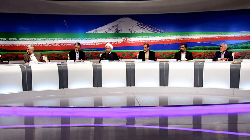 Iranian presidential candidates (L to R) Tehran's mayor Mohammad Baqer Qalibaf, top nuclear negotiator Saeed Jalili, former parliament speaker Gholam-Ali Haddad Adel, former chief nuclear negotiator Hassan Rowhani, former foreign minister Ali Akbar Velayati, former chief of the Revolutionary Guards Mohsen Rezai, Mohammad Gharazi and former first vice president Mohammad Reza Aref attend a live debate on state television in Tehran on June 7, 2013, ahead of the upcoming presidential elections. AFP PHOTO/ IRIB/
