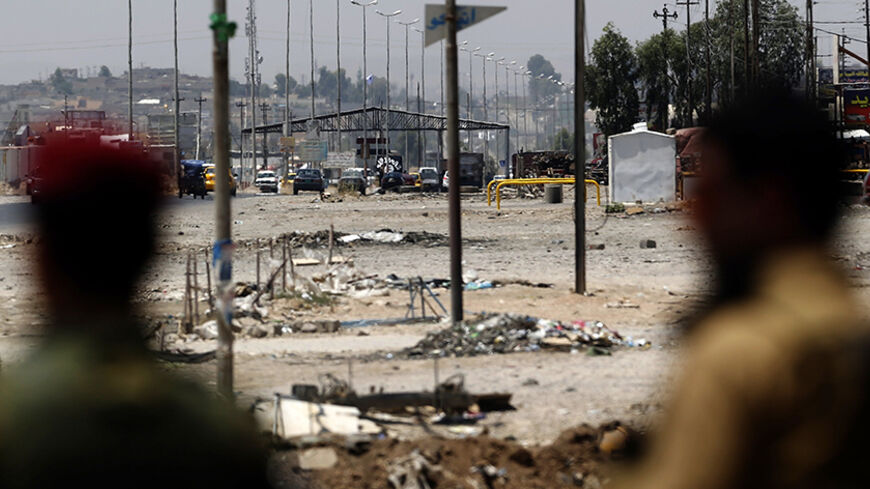 Kurdish Peshmerga forces look at a checkpoint held by militants of the Islamic State of Iraq and the Levant (ISIL) jihadist group on June 16, 2014 in Iraq's second city of Mosul. Since ISIL began its spectacular assault in Mosul late on June 9, jihadist fighters have captured a large swathe of northern and north-central Iraq, prompting as many as half a million people to flee their homes.     AFP PHOTO/KARIM SAHIB        (Photo credit should read KARIM SAHIB/AFP/Getty Images)