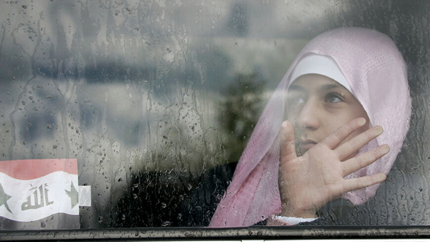 An Iraqi girl in sits in a car outside a shopping mall in Amman January 31, 2007. Violence in Iraq and instability in Lebanon are driving hundreds of thousands of people abroad in an upheaval not matched in the Middle East since the exodus of Palestinian refugees when Israel was created in 1948. To match feature MIGRATION-MIDEAST. REUTERS/Ali Jarekji (JORDAN) - RTR1LU56