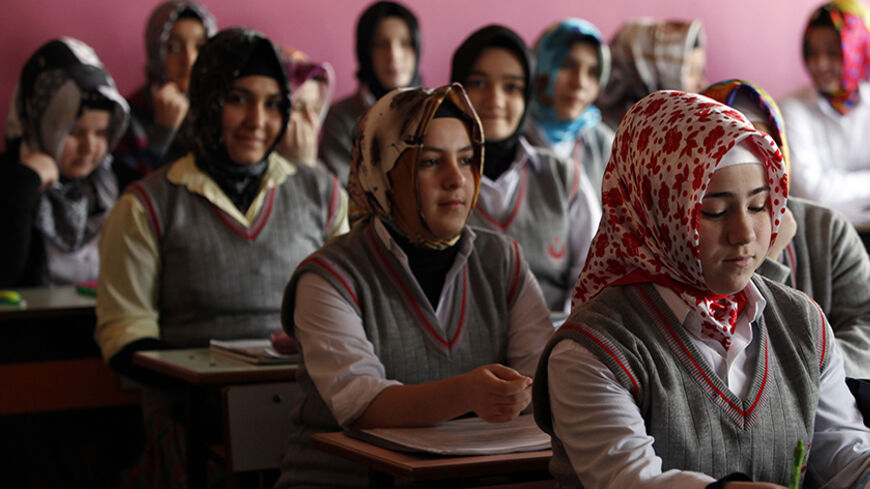 Turkish girls attend a class at the Kazim Karabekir Girls' Imam-Hatip School in Istanbul February 10, 2010. The imam-hatip network is a far cry from the western stereotype of the madrassa as an institution that teaches the Koran by rote and little else. Originally founded to educate Muslim religious functionaries in the 1920s, the imam-hatip syllabus devotes only around 40 percent of study to religious subjects like Arabic, Islamic jurisprudence and rhetoric. The rest is given over to secular topics.  To ma