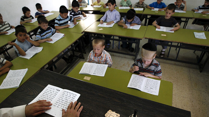 Ultra Orthodox students attend a religious studies class at Kehilot Yaacov Torah School for boys in Ramot, Jerusalem June 24, 2010. Israel's ultra-Orthodox minority has long been at odds with the Jewish state's highest judicial authority over edicts which some devout Jews say interfere with their religious lifestyle. Ultra-Orthodox Jews protested in Israel last week against a court order to desegregate a religious school and force Jewish girls of European and Middle Eastern descent to study together. REUTER
