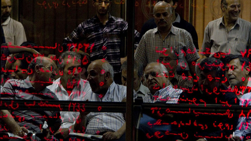 EDITORS' NOTE: Reuters and other foreign media are subject to Iranian restrictions on their ability to report, film or take pictures in Tehran. 
Investors look at an electronic display board, reflected in a glass partition, at the Tehran stock exchange September 15, 2010. The Tehran Stock Exchange has reached record highs in recent months, drawing increasing attention from small investors but also raising concerns about why stocks are rising in a difficult economic climate and how long the upward trend can 