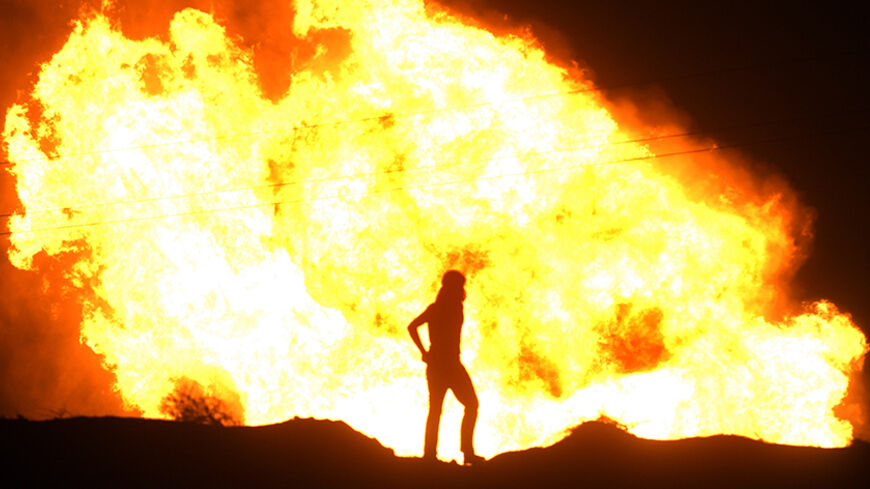 Flames rise from an Egyptian pipeline distribution station after an attack in the Sinai peninsula July 12, 2011. Saboteurs blew up the distribution station in northern Sinai on Tuesday that supplies natural gas to Israel, the official MENA news agency said. It was the fourth attack on facilities supplying Egyptian gas to Israel this year. REUTERS/Stringer (EGYPT - Tags: POLITICS CIVIL UNREST) - RTR2OS5A