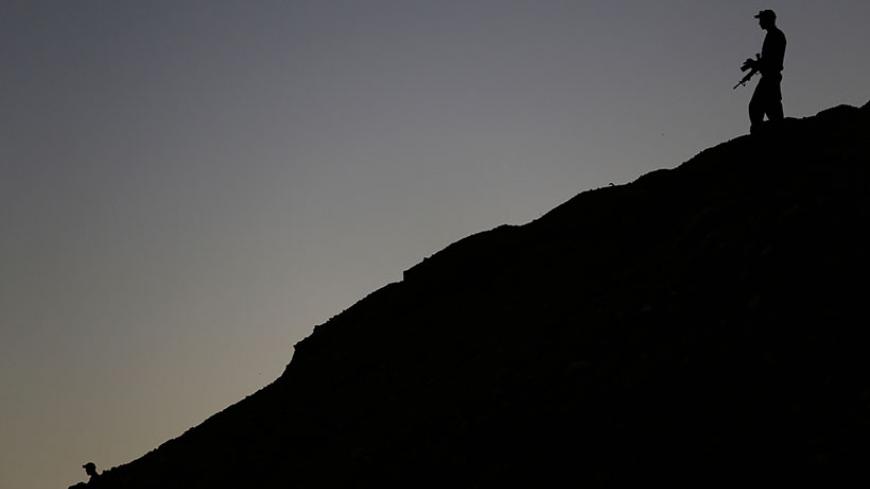 An Israeli soldier stands guard outside a navy base in the Red Sea resort city of Eilat March 10, 2014. REUTERS/Amir Cohen (ISRAEL - Tags: POLITICS MILITARY) - RTR3GGYB