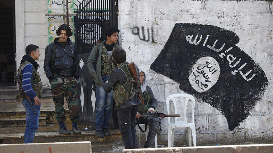 Free Syrian Army fighters stand at a former base used by fighters from the Islamic State in Iraq and the Levant (ISIL), after the ISIL withdrew from the town of Azaz, near the Syrian-Turkish border, March 11, 2014. Syrian refugees in this border outpost were delighted to hear their home town of Azaz had been liberated - not from Bashar al-Assad's troops but from al-Qaeda fighters who subjected them to a regime that included torture and public beheadings. For Syrians who three years ago rose up against 43 ye