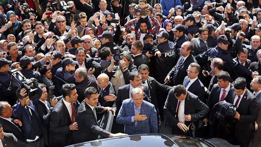 Turkey's Prime Minister Tayyip Erdogan acknowledges supporters during the municipal elections outside a polling station in Istanbul March 30, 2014. Erdogan looks set to win Sunday's municipal elections that have become a crisis referendum on his 10-year rule as he tries to ward off graft allegations and stem a stream of damaging security leaks. REUTERS/Murad Sezer (TURKEY - Tags: POLITICS ELECTIONS) - RTR3J6TG