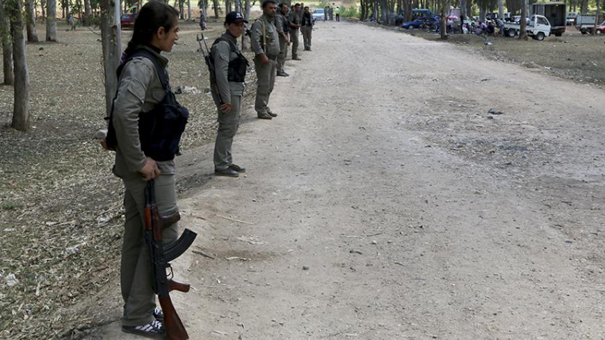Kurdish Democratic Union Party (PYD) members stand guard during a Labour Day celebration in Efrin May 1, 2014. REUTERS/Mahmoud Hebbo (SYRIA - Tags: POLITICS CIVIL UNREST SOCIETY) - RTR3NEUG