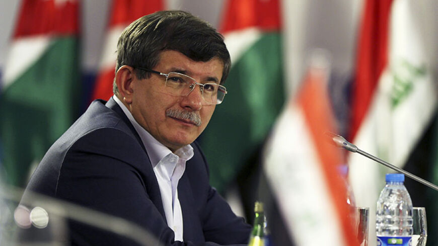 Turkish Foreign Minister Ahmet Davutoglu attends the opening of a meeting of foreign ministers at the Zaatari refugee camp in the Jordanian city of Mafraq, near the border with Syria, May 4, 2014. Foreign ministers of major refugee hosting countries attended a one-day meeting in the Zaatari refugee camp to discuss a resolution for the Syrian refugee crisis. The meeting - the third for countries harbouring the largest number of Syrian refugees - brought together Foreign Ministers from Jordan, Lebanon, Egypt,