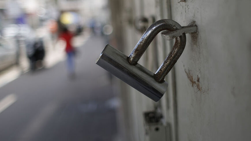 A closed shop is seen in the West Bank city of Ramallah June 8, 2014. Shops were shuttered in the Palestinian commercial capital on Sunday in solidarity with nearly 300 Palestinian prisoners on hunger strike against Israeli detention without trial. REUTERS/Mohamad Torokman (WEST BANK - Tags: POLITICS BUSINESS) - RTR3SQKE