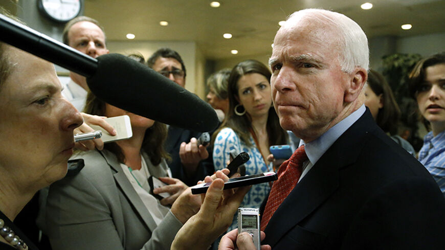 U.S. Senator John McCain (R-AZ) (R) talks to reporters after a closed-door Senate Armed Services Committee briefing on the Bergdahl prisoner swap at the U.S. Capitol in Washington June 10, 2014. The White House has been trying to appease angry lawmakers since U.S. President Barack Obama announced on May 31 that U.S. Army Sergeant Bowe Bergdahl had been exchanged for the five inmates from the U.S. military prison at Guantanamo Bay in Cuba. REUTERS/Jonathan Ernst (UNITED STATES - Tags: POLITICS MILITARY) - RT