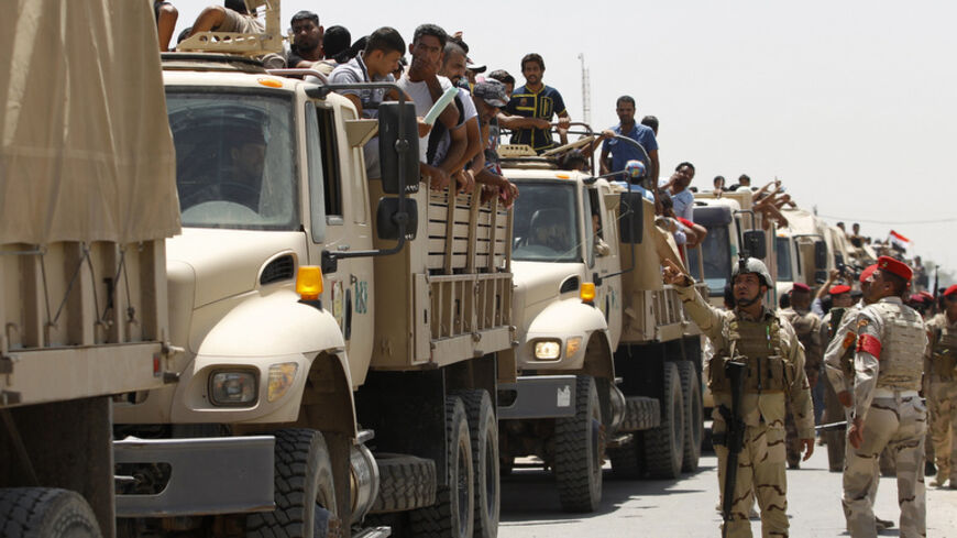 Volunteers, who have joined the Iraqi Army to fight against the predominantly Sunni militants who have taken over Mosul and other Northern provinces, travel in army trucks in Baghdad June 14, 2014. Iraqi Prime Minister Nuri al-Maliki told army officers in the city of Samarra that volunteers were arriving to help defeat Islamist militants who have swept through Sunni Muslim territory towards Baghdad. REUTERS/Thaier Al-Sudani (IRAQ - Tags: CIVIL UNREST POLITICS MILITARY) - RTR3TQL8