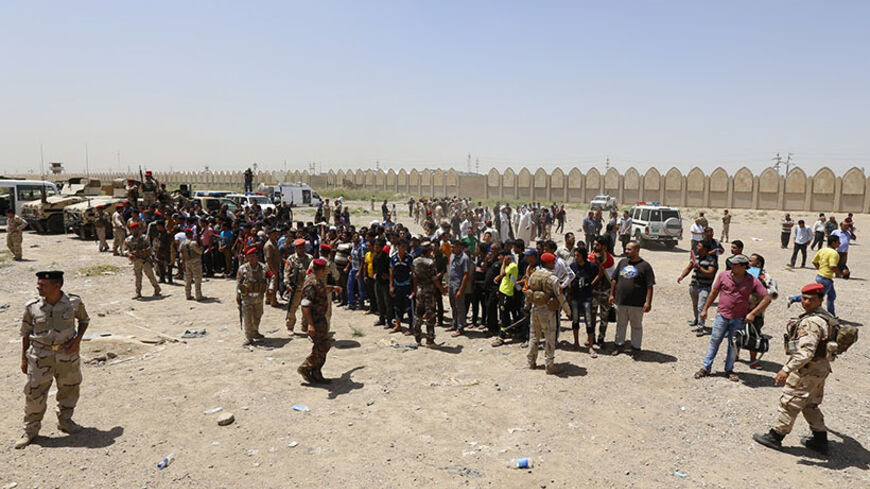 Volunteers who have joined the Iraqi Army to fight against the predominantly Sunni militants, who have taken over Mosul and other Northern provinces, chant slogans in Baghdad, June 14, 2014. Iraq's most senior Shi'ite Muslim cleric urged followers to take up arms against a full-blown Sunni militant insurgency to topple Shi'ite Prime Minister Nuri al-Maliki, escalating a conflict that threatens civil war and a possible break-up of the country.   REUTERS/Thaier Al-Sudani  (IRAQ - Tags: CIVIL UNREST POLITICS M