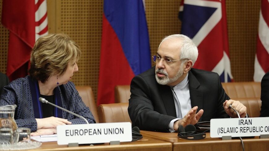 European Union Foreign Policy Chief Catherine Ashton (L) and Iranian Foreign Minister Mohammad Javad Zarif wait for the begin of talks in Vienna June 17, 2014. Six world powers and Iran began their fifth round of nuclear negotiations on Tuesday in hopes of salvaging prospects for a deal over Tehran's disputed atomic activity by a July deadline. REUTERS/Heinz-Peter Bader (AUSTRIA - Tags: POLITICS ENERGY) - RTR3U83T