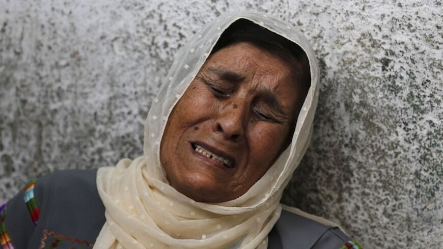 The mother of Palestinian Mohammed Attallah mourns his death at a hospital in the West Bank city of Ramallah June 22, 2014. Israeli troops killed two Palestinians on Sunday, one of them Attallah, Palestinian medics and a militant group said, as Israel pressed on with its crackdown on Hamas, the Islamist group it accuses of abducting three Israeli teens. In Ramallah, the Islamic Jihad militant group said one of its members was killed by Israeli gunfire.The Israeli military said it was "not familiar" with th