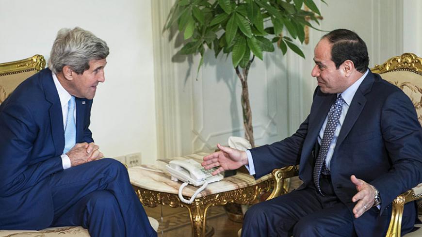 Egypt's President Abdel Fattah al-Sisi (R) and U.S. Secretary of State John Kerry talk before a meeting at the Presidential Palace in Cairo June 22, 2014. Kerry arrived in Cairo on Sunday for talks with Egypt's President Abdel Fattah al-Sisi over Egypt's crackdown on the Muslim Brotherhood and the threat which the conflict in Iraq poses to the Middle East. REUTERS/Brendan Smialowski/Pool (EGYPT - Tags: POLITICS TPX IMAGES OF THE DAY) - RTR3V3FP
