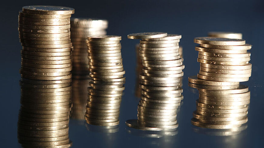 Stacks of Turkey's lira coins are seen in this picture illustration taken in Istanbul July 23, 2013. Turkey's central bank raised interest rates on Tuesday and said it would, if necessary, take further steps to stop the lira from falling. The move - a rise in the overnight lending rate to 7.25 percent from 6.5 percent - was a reaction to capital outflows that have knocked the lira down as much as 9 percent against the dollar.  REUTERS/Osman Orsal (TURKEY - Tags: BUSINESS POLITICS) - RTX11W1S