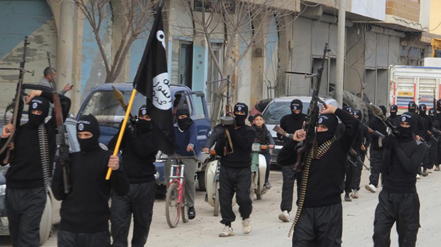 Fighters of al-Qaeda linked Islamic State of Iraq and the Levant carry their weapons during a parade at the Syrian town of Tel Abyad, near the border with Turkey January 2, 2014. Picture taken January 2, 2014. REUTERS/Yaser Al-Khodor (SYRIA - Tags: POLITICS CIVIL UNREST CONFLICT) - RTX170U3