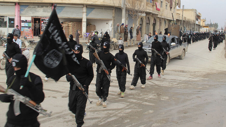 Fighters of al-Qaeda linked Islamic State of Iraq and the Levant carry their weapons during a parade at the Syrian town of Tel Abyad, near the border with Turkey January 2, 2014. Picture taken January 2, 2014.     REUTERS/Yaser Al-Khodor (SYRIA - Tags: POLITICS CIVIL UNREST CONFLICT) - RTX170U8