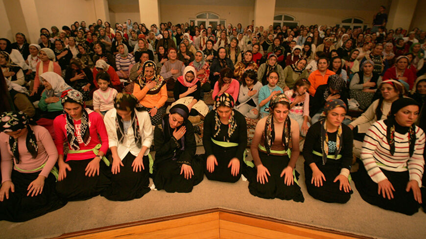 - PHOTO TAKEN 27OCT05 - Alevi women rock back and forth as they worship in the haunting rhythm and religious chants during their prayers "Cem Ayini" at an Alevi cemevi in Istanbul October 27, 2005. Long oppressed under Ottoman rule, the Alevis say they still face discrimination, even though the government has officially championed religious freedoms and human rights as it bids to gain membership to the [European Union]. Photo taken October 27, 2005. - RTXNXQC