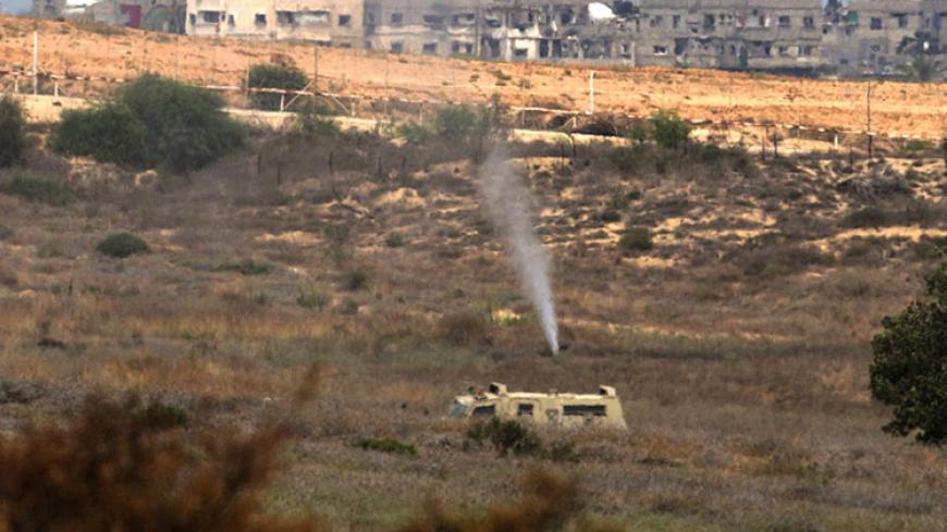Gas deployed by the Israeli army gushes out of a hole in a tunnel, which was used by Hamas militants in an attack on July 21, during an operation to search for tunnels dug by the Palestinian militants, just outside the Gaza Strip July 22, 2014. Israel pounded targets across the Gaza Strip on Tuesday, saying no ceasefire was near as top U.S. and U.N. diplomats pursued talks on halting fighting that has claimed more than 600 lives.With the conflict entering its third week, the Palestinian death toll rose to 6