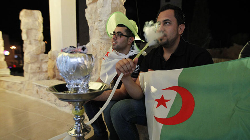 Palestinians watch the 2014 FIFA World Cup football second round match between Algeria and Germany in the West Bank city of Ramallah on June 30, 2014. AFP PHOTO / ABBAS MOMANI (Photo credit should read ABBAS MOMANI/AFP/Getty Images)