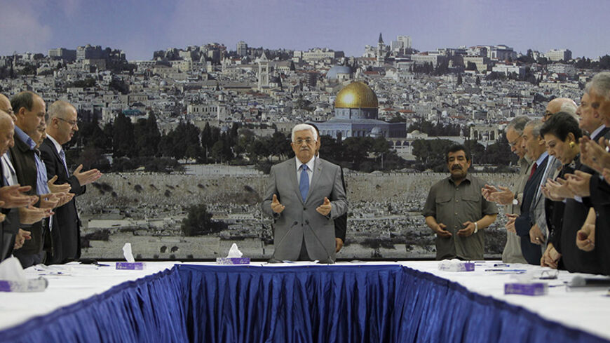 Palestinian president Mahmud Abbas (C) prays prior a meeting with his leadership in the West Bank city of Ramallah on July 9, 2014. Abbas has demanded Israel "immediately stop" its air campaign on the Gaza Strip and called on the international community to pressure the Jewish state. Israeli warplanes pounded targets in the Gaza Strip today as a major campaign to stop volleys of Palestinian rocket fire entered its second day. AFP PHOTO / ABBAS MOMANI (Photo credit should read ABBAS MOMANI/AFP/Getty Im