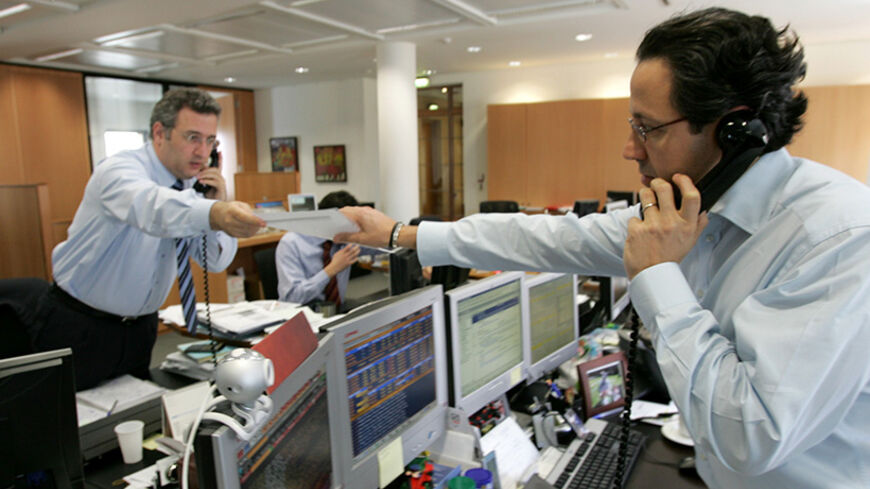 Traders are seen busy working in Audi Bank's dealing room before the end of Beirut's stock exchange trading session in Beirut, Lebanon in this April 3, 2006 file photo. Picture taken April 3, 2006. REUTERS/Jamal Saidi - RTR1CEXZ