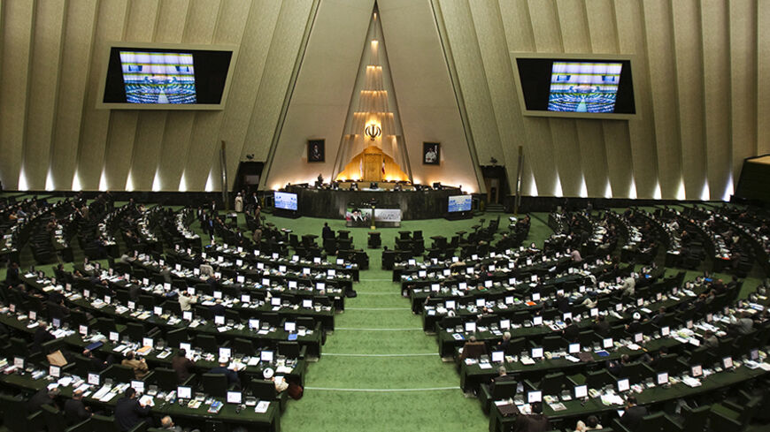 EDITORS' NOTE: Reuters and other foreign media are subject to Iranian restrictions on leaving the office to report, film or take pictures in Tehran.

A general view of a parliament session in Tehran November 1, 2011. Iran's parliament is threatening to impeach two of Mahmoud Ahmadinejad's ministers, in a new wave of pressure against the president who is under attack from lawmakers. REUTERS/Raheb Homavandi (IRAN - Tags: POLITICS BUSINESS CRIME LAW) - RTR2THAJ