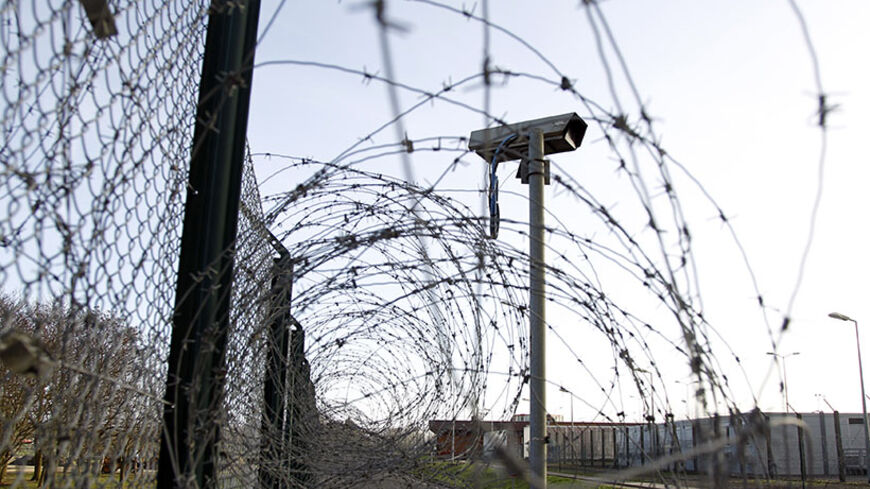 A surveillance camera is seen near a barbed-wire fence inside the Chinon Nuclear Power Plant in Chinon, centre France, January 6, 2012. France will take new measures to tighten security around its 58 nuclear power plants, Interior Minister told daily Le Parisien on Friday, after Greanpeace activists succeeded in entering two of them last month. REUTERS/Charles Platiau (FRANCE - Tags: ENERGY) - RTR2VYIR