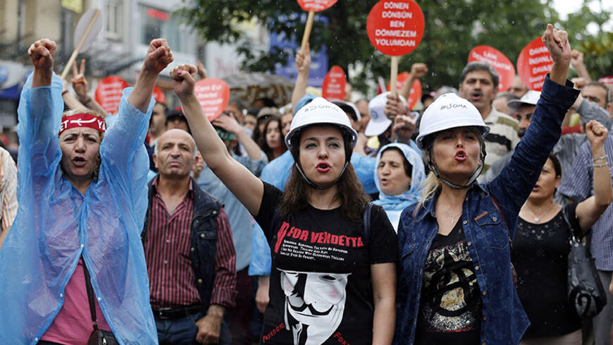 Alevi demonstrators shout anti-goverment slogans during a protest against the latest violence in Okmeydani, a working-class district in the center of the city, in Istanbul May 25, 2014. Two people died last week after clashes between Turkish police and protesters in Okmeydani, a working-class district of Istanbul, stirring fears of further unrest as the anniversary of last year's anti-government demonstrations approaches. Okmeydani is home to a community of Alevis, a religious minority in mainly Sunni Musli