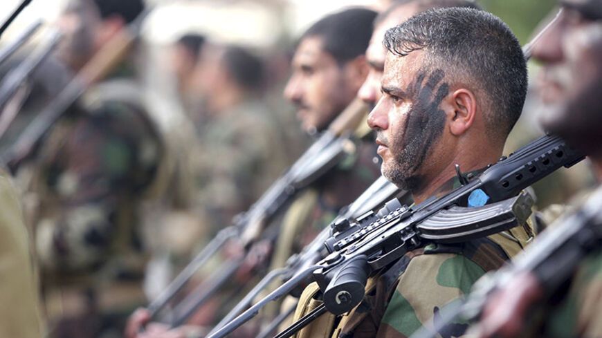 Mehdi Army fighters loyal to Shi'ite cleric Moqtada al-Sadr stand during a military-style training in Najaf June 20, 2014. Iraqi forces were massing north of Baghdad on Friday, aiming to strike back at Sunni Islamists whose drive toward the capital prompted the United States to send military advisers to stiffen government resistance.  REUTERS/Alaa Al-Marjani (IRAQ - Tags: CIVIL UNREST POLITICS MILITARY) - RTR3UW3C