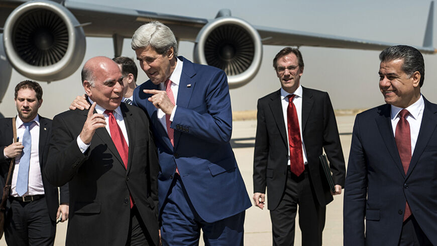 U.S. Secretary of State John Kerry (centre, R) talks with Fuad Hussein (centre,L), chief of staff at the presidency of the Kurdistan Regional Government, while accompanied by Kurdish regional foreign relations minister Falah Mustafa Bakir (R) and other officials, at Arbil International Airport June 24, 2014. Kerry was in Iraqi Kurdistan on Tuesday to urge its leaders not to withdraw from the political process in Baghdad after their forces took control of the northern oil city of Kirkuk. Peshmerga fighters,