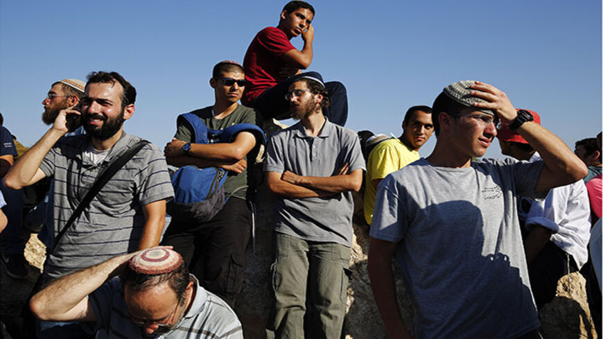 Israelis attend the joint funeral of three Israeli teens, Gil-Ad Shaer, U.S.-Israeli national Naftali Fraenkel, both 16, and Eyal Yifrah, 19, who were abducted and killed in the occupied West Bank, in the Israeli city of Modi'in July 1, 2014. Tens of thousands of mourners joined in an outpouring of national grief on Tuesday at the burial of three Israeli teenagers whose kidnapping and killing Israel blamed on the Palestinian Islamist group Hamas. The Islamist group has neither confirmed nor denied involveme