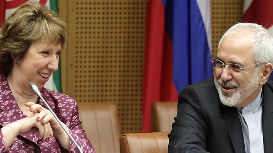 European Union Foreign Policy Chief Catherine Ashton (L) and Iranian Foreign Minister Mohammad Javad Zarif wait to begin talks in Vienna July 3, 2014. Iran and six world powers are aiming for a deal this month in marathon talks to end their long-running dispute over Tehran's nuclear program and dispel fears of a new Middle East war. REUTERS/Heinz-Peter Bader  (AUSTRIA - Tags: POLITICS) - RTR3WX57