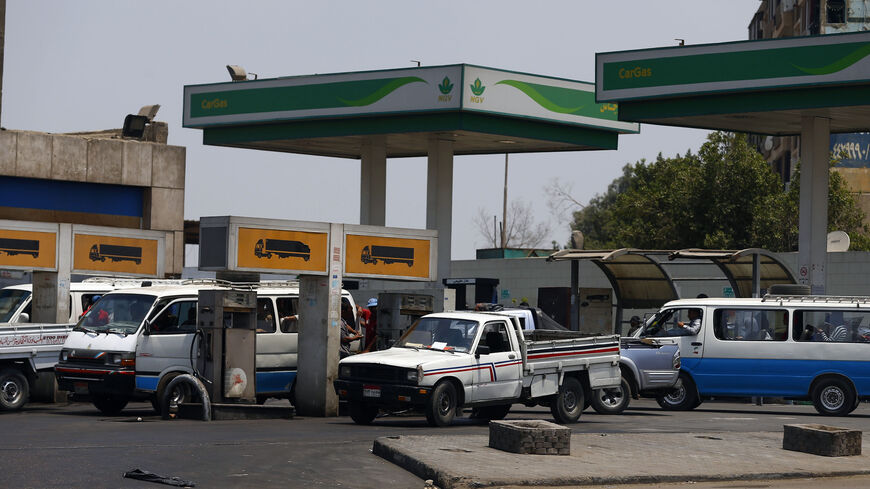A microbus waits with other vehicles for fuel at a petrol station in Cairo July 6, 2014. Egypt's Prime Minister Ibrahim Mehleb has sought to justify politically sensitive subsidy cuts on fuel and natural gas which took effect on Saturday, saying they were a necessary part of fixing an economy hammered by three years of turmoil. Egypt had overnight on Friday slashed its subsidies for car fuel and natural gas, increasing their prices by more than 70 percent. REUTERS/Amr Abdallah Dalsh (EGYPT - Tags: POLITICS