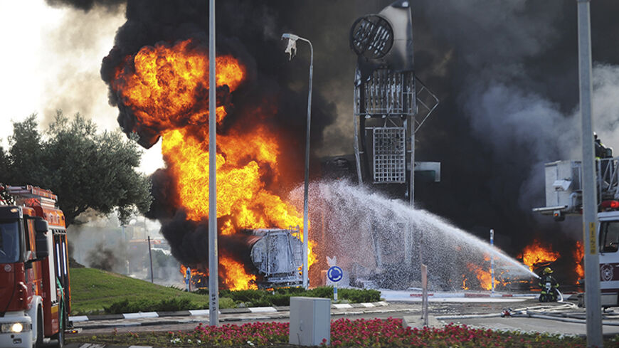 Israeli fire-fighters extinguish a fire that broke out after a rocket hit a petrol station in the southern Israeli city of Ashdod July 11, 2014. Israel pressed on for a fourth day with its Gaza offensive on Friday, striking the Hamas-dominated enclave from air and sea, as Palestinian militants kept up rocket attacks deep into the Jewish state. One rocket on Friday hit the petrol station in Israel's port city of Ashdod, causing a huge blaze and at least three people were seriously wounded, an ambulance spoke