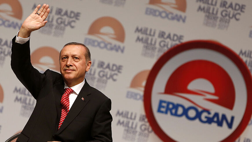 Turkey's Prime Minister and presidential candidate Tayyip Erdogan greets his supporters at the end of a meeting to launch his election campaign in Istanbul July 11, 2014. REUTERS/Murad Sezer (TURKEY - Tags: POLITICS ELECTIONS) - RTR3Y75D