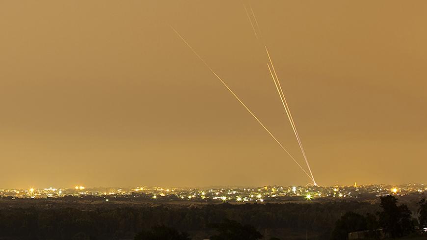 Smoke trails are seen as rockets are launched towards Israel from the northern Gaza Strip July 12, 2014.  Hamas militants launched ten rockets at Tel Aviv on Saturday, causing no casualties or damage, in the largest salvo yet on Israel's main business hub, since Israel launched its Gaza offensive against the Islamist group, five days ago. Picture shot using a long exposure. REUTERS/Amir Cohen (ISRAEL - Tags: POLITICS CIVIL UNREST MILITARY CONFLICT TPX IMAGES OF THE DAY) - RTR3YB6I