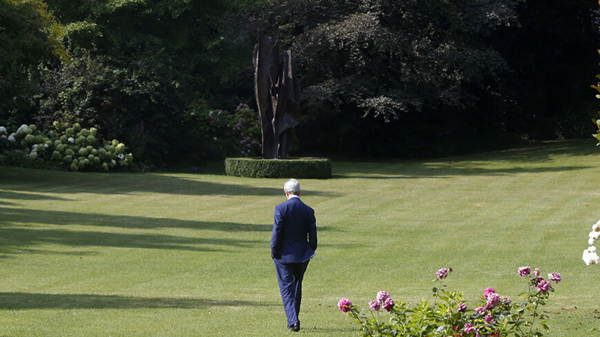 U.S. Secretary of State John Kerry walks in the garden of the U.S. ambassador's residence before meeting with Turkish Foreign Minister Ahmet Davutoglu in Paris July 26, 2014. REUTERS/Charles Dharapak/Pool (FRANCE - Tags: POLITICS) - RTR406S0