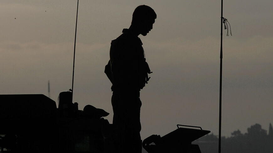 An Israeli soldier stands atop an armoured vehicle at a staging area near the border with the Gaza Strip July 31, 2014. Israel pressed ahead with its Gaza offensive saying it was days from achieving its core goal of destroying all Islamist guerrilla cross-border attack tunnels, but a soaring Palestinian civilian toll has triggered international alarm. REUTERS/Siegfried Modola (ISRAEL - Tags: CIVIL UNREST MILITARY POLITICS CONFLICT) - RTR40QWU