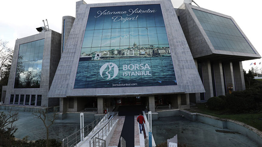 A man enters the Bourse Istanbul in Istanbul December 17, 2013. Turkey's Bourse Istanbul could acquire a minority stake in Nasdaq OMX Group as part of a tie-up that will involve the Turkish exchange using Nasdaq's market technologies, its chairman Ibrahim Turhan said on December 31, 2013. Bourse Istanbul will buy stock trading and clearing software and infrastructure from Nasdaq OMX and will be able to use and resell the software in 25 countries, in a move designed to attract more trade from the world's lea