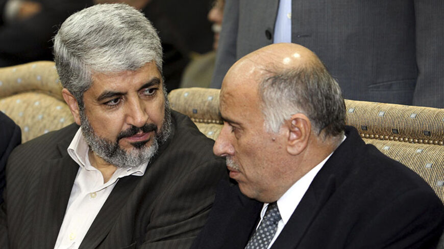 Hamas leader Khaled Meshaal (L) sits beside senior Fatah leader Jibril Rajoub during the wake for Ata Abbas, the older brother of Palestinian President Mahmoud Abbas ,at al-Yarmouk camp near Damascus January 4, 2011. Atta Abbas, approximately 80 years old, died on Sunday of natural causes, according to a Hamas official. REUTERS/Hamas/Handout (SYRIA - Tags: POLITICS OBITUARY) FOR EDITORIAL USE ONLY. NOT FOR SALE FOR MARKETING OR ADVERTISING CAMPAIGNS. THIS IMAGE HAS BEEN SUPPLIED BY A THIRD PARTY. IT IS D