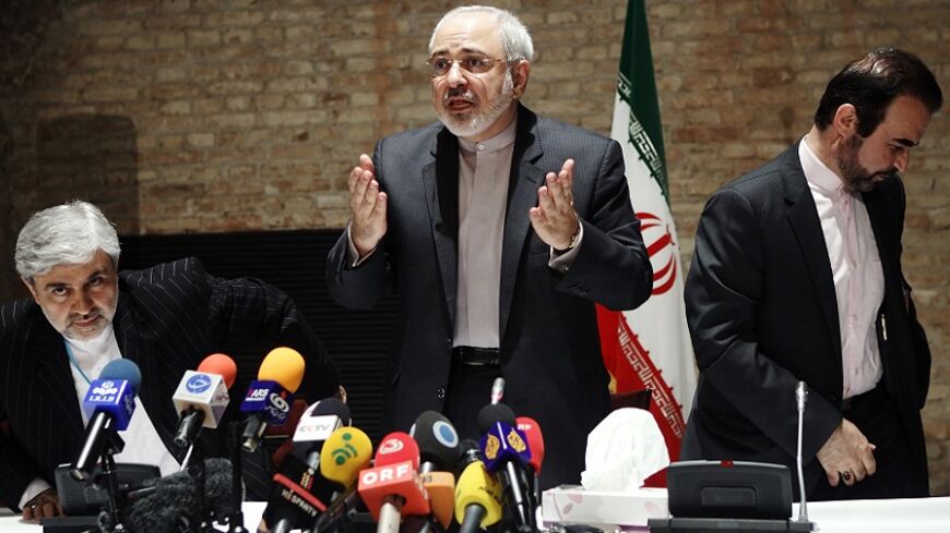 Iranian Foreign Minister Mohammad Javad Zarif (C) and diplomats leave a news conference in Vienna July 15, 2014. Zarif suggested on Tuesday that six world powers are leaning towards extending nuclear talks with Tehran beyond a July 20 deadline although both sides still hoped to reach an agreement over the next five days. REUTERS/Heinz-Peter Bader (AUSTRIA - Tags: POLITICS ENERGY) - RTR3YRRR