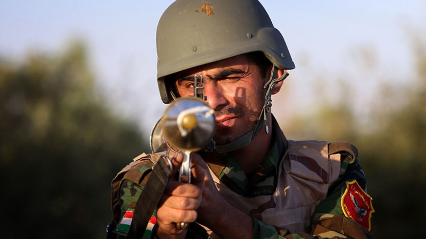 An Iraqi Kurdish Peshmerga fighter poses for a picture on the front line in Makhmur, about 280 kilometres (175 miles) north of the capital Baghdad, during clashes with Islamic State (IS) militants on August 9, 2014. Makhmur, is one of the areas that had been attacked by jihadist fighters in recent days. AFP PHOTO/SAFIN HAMED        (Photo credit should read SAFIN HAMED/AFP/Getty Images)