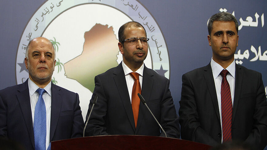 Iraqi newly elected parliament speaker Salim al-Juburi (C) stands between his deputies Haidar Al Abadi (L) and Aram Sheikh Mohamad (R) in Baghdad on July 15, 2014. Iraq's fractious parliament elected a speaker after two failed sittings, with al-Juburi winning comfortably according to a tally announced live on state television. The much-delayed election kickstarts a political process which should also see lawmakers agree on a federal president, who then designates the largest bloc, the candidate of which has